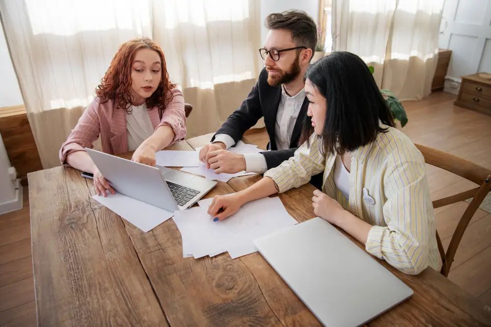 Group of people reviewing immigration documents and paperwork at a desk