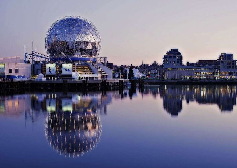 Science World in Vancouver, British Columbia, reflected in False Creek at dusk.
