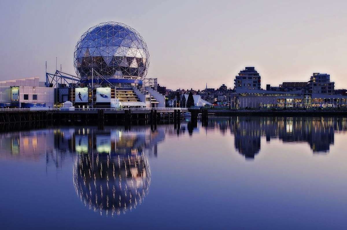 Science World in Vancouver, British Columbia, reflected in False Creek at dusk.