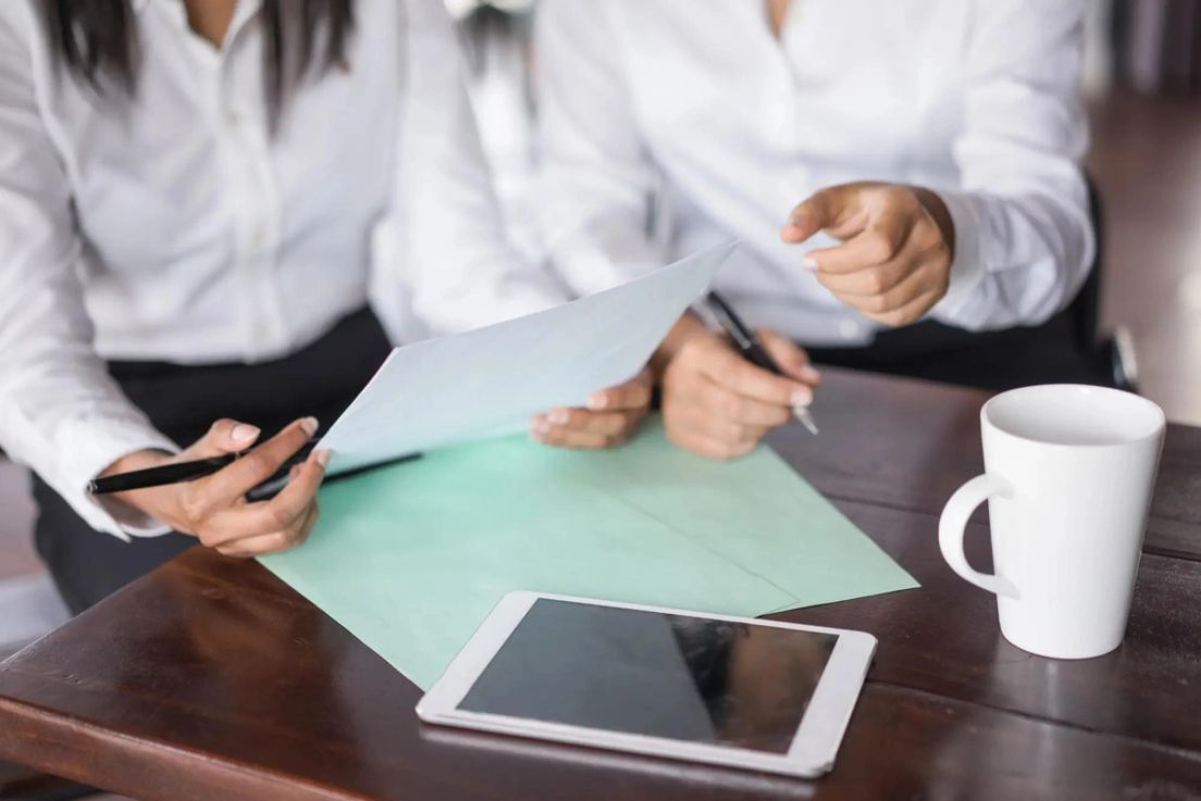 Reviewing a Procedural Fairness Letter (PFL) for Canadian immigration application at a desk with documents and tablet