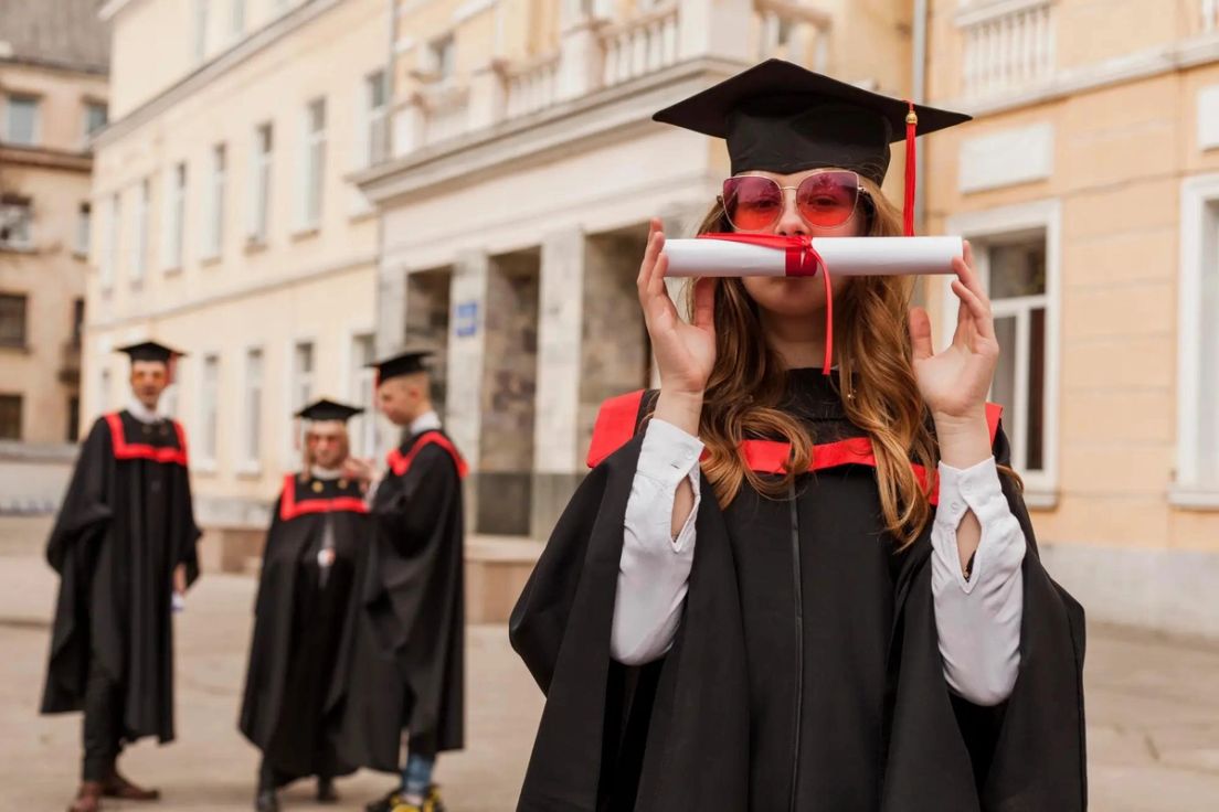 International student in graduation gown holding diploma, possibility of bringing common-law partner to Canada on student visa